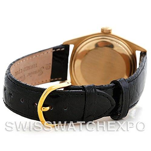 The image shows the back view of a Rolex President 1803 Men
s Yellow Gold Champagne Dial 1803 Men
s Yellow Gold Champagne Dial model watch, highlighting its black leather strap and gold buckle.