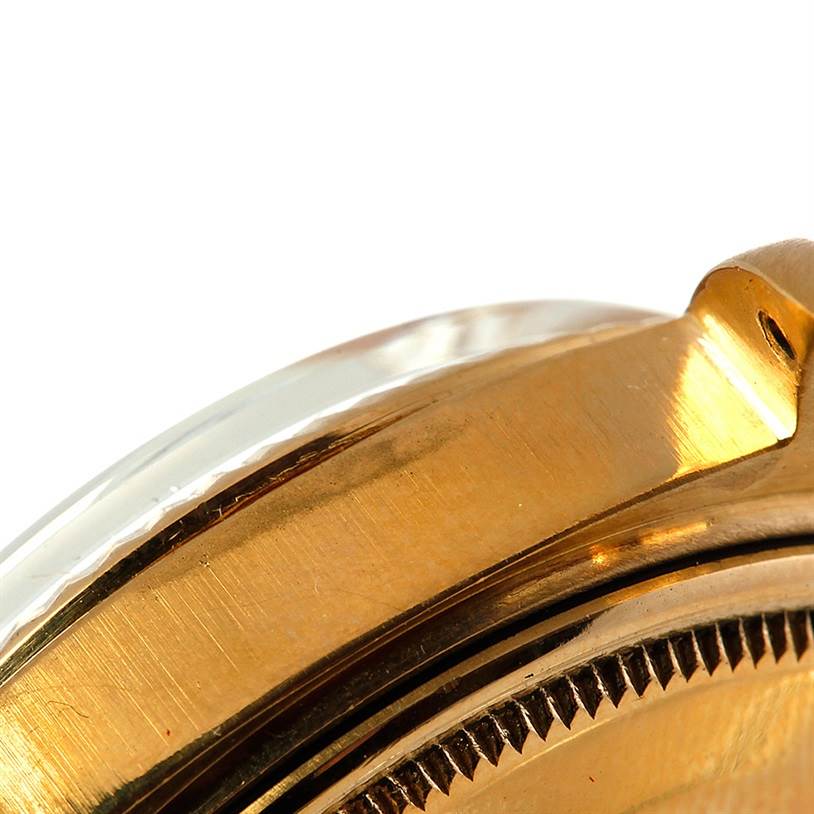 This close-up image shows the bezel and case of the Rolex President 1803 Men
s Yellow Gold Champagne Dial 1803 Men
s Yellow Gold Champagne Dial model watch.