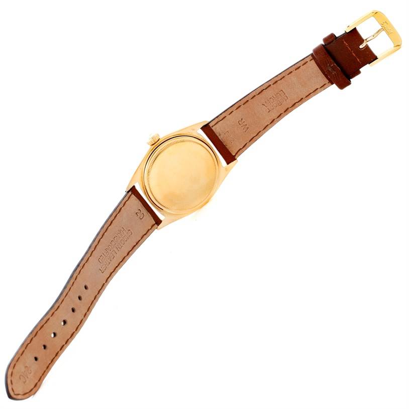 The image shows the back and brown leather strap of a Rolex President 1803 Men
s Yellow Gold Champagne Dial 1803 Men
s Yellow Gold Champagne Dial model watch.