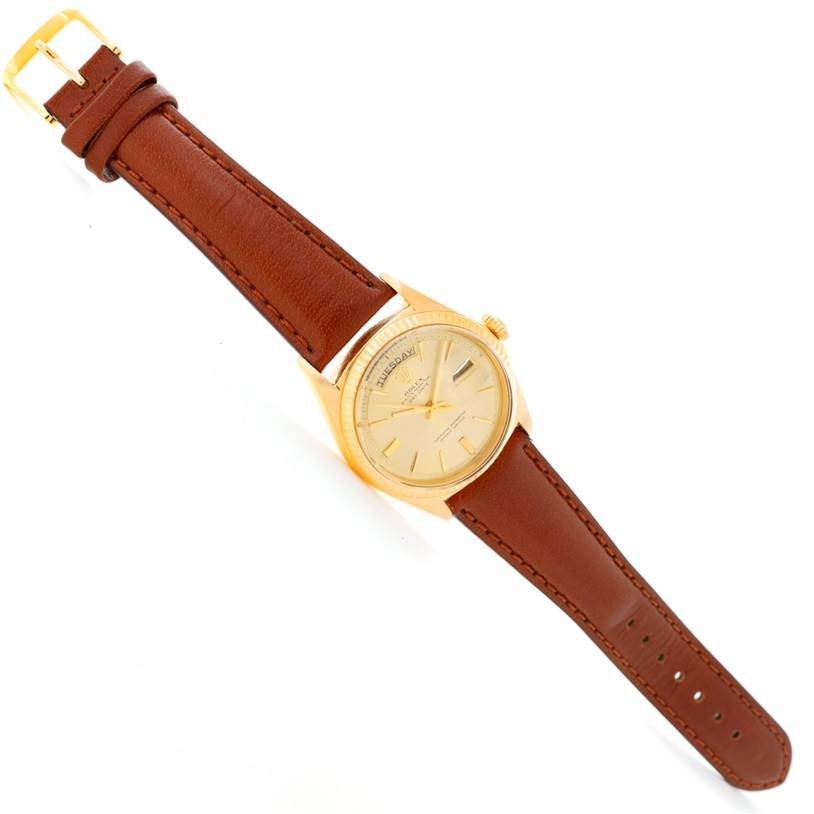 This image shows a Rolex President 1803 Men
s Yellow Gold Champagne Dial 1803 Men
s Yellow Gold Champagne Dial model watch at an angled top-down view, showcasing its dial, case, crown, and leather strap.