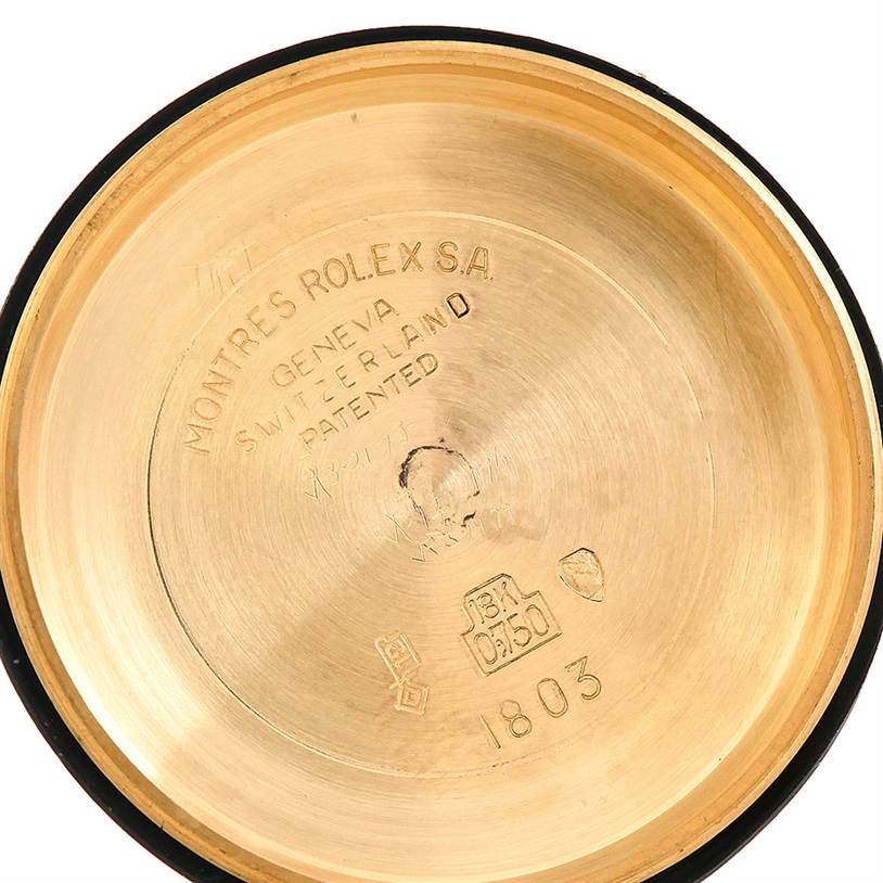 The image shows the inside of the back case of a Rolex President 1803 Men
s Yellow Gold Champagne Dial 1803 Men
s Yellow Gold Champagne Dial model watch, showcasing engravings and hallmarks.