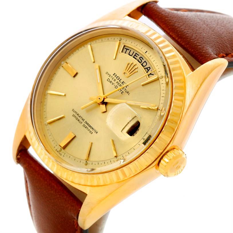 The Rolex President 1803 Men
s Yellow Gold Champagne Dial 1803 Men
s Yellow Gold Champagne Dial watch is shown at an angle highlighting its gold dial, day/date display, crown, and a brown leather strap.