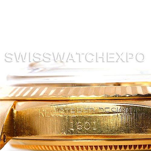 The image shows a close-up side angle of the case and bezel of a Rolex President 1601 Men
s Yellow Gold Silver Dial 1601 Men
s Yellow Gold Silver Dial model watch, highlighting the "Registered Design 1801" engraving.