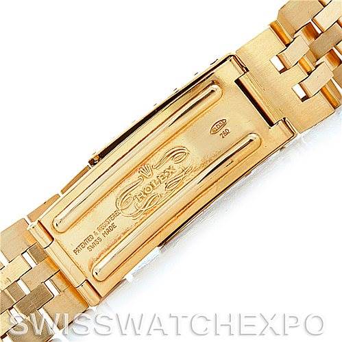The image shows a close-up of the clasp of a Rolex President 1601 Men
s Yellow Gold Silver Dial 1601 Men
s Yellow Gold Silver Dial watch band, highlighting the engraved details and brand logo.