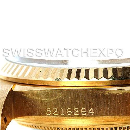 The image shows a close-up of the side of the Rolex President 16018 Men
s Yellow Gold Silver Dial 16018 Men
s Yellow Gold Silver Dial watch, displaying the serial number and part of the gold bezel.