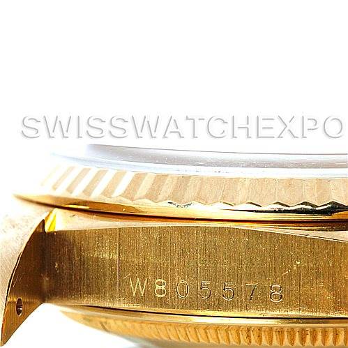 This image shows a close-up side view of a Rolex President 18238 Men
s Yellow Gold Champagne Dial 18238 Men
s Yellow Gold Champagne Dial model watch, featuring the case markings and the fluted bezel.