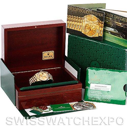 The image shows a Rolex President 18238 Men
s Yellow Gold Champagne Dial 18238 Men
s Yellow Gold Champagne Dial model watch in its open box with accompanying booklets and warranty card.