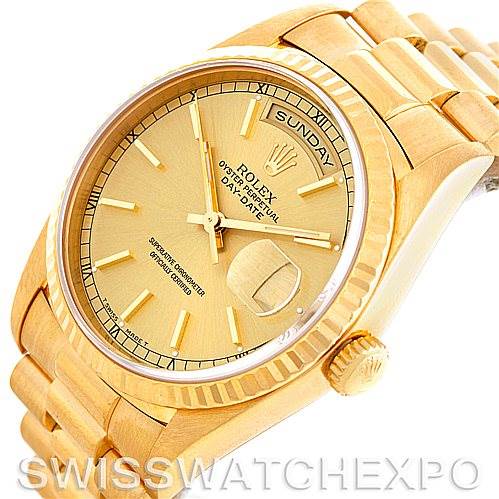 The image shows a close-up angled view of the Rolex President 18238 Men
s Yellow Gold Champagne Dial 18238 Men
s Yellow Gold Champagne Dial watch, highlighting the golden face, day-date display, bracelet, and bezel.