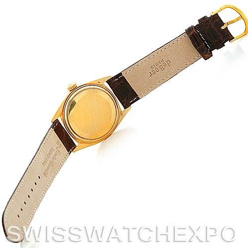 This image shows the back case and leather strap of a Rolex President 1803 Men's Yellow Gold White Dial 1803 Men's Yellow Gold White Dial model watch from a top view angle.