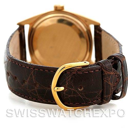 This image shows the back view of a Rolex President 1803 Men's Yellow Gold White Dial 1803 Men's Yellow Gold White Dial watch with a gold case and a leather strap, featuring a gold buckle.