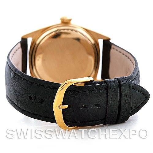 The image shows the back view of a Rolex President 1601 Men's Yellow Gold Black Dial 1601 Men's Yellow Gold Black Dial model watch with a black leather strap and gold buckle.