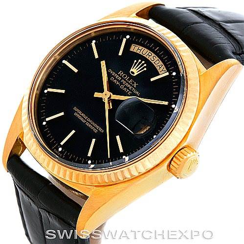 The image shows a President model Rolex watch from an angled perspective, displaying the black dial, day-date window, gold case, and leather strap.