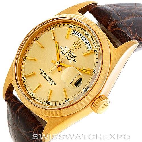 The Rolex President 1803 Men
s Yellow Gold Champagne Dial 1803 Men
s Yellow Gold Champagne Dial model watch is shown at an angled close-up, displaying its gold case, dial, crown, and brown leather strap.