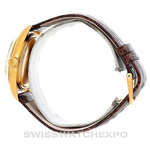 The Rolex President 1803 Men
s Yellow Gold Champagne Dial 1803 Men
s Yellow Gold Champagne Dial watch is shown from a side angle highlighting the crown, case, and brown leather strap with a gold buckle.