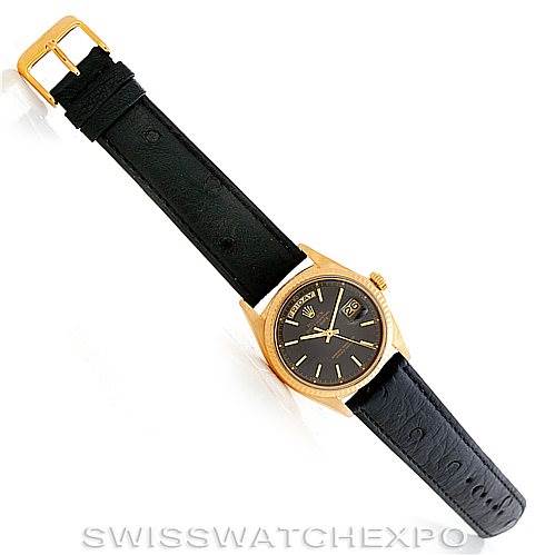 The Rolex President 1803 Men's Yellow Gold Grey Dial 1803 Men's Yellow Gold Grey Dial model watch is shown from a top view, displaying its black leather strap and gold case.