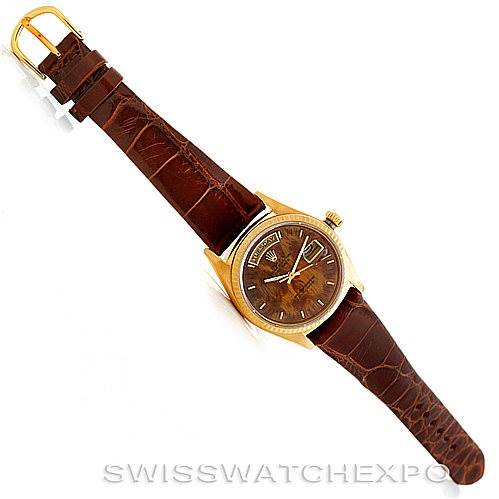 This image shows a Rolex President 18038 Men's Yellow Gold Brown Dial 18038 Men's Yellow Gold Brown Dial model watch with a brown leather strap, gold case, and a brown dial, viewed from a top-down angle.