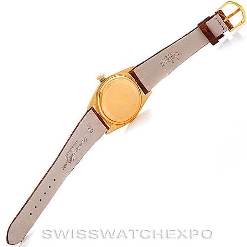 The image shows the back view of a Rolex President 18038 Men's Yellow Gold Brown Dial 18038 Men's Yellow Gold Brown Dial model watch with a leather strap and gold buckle.