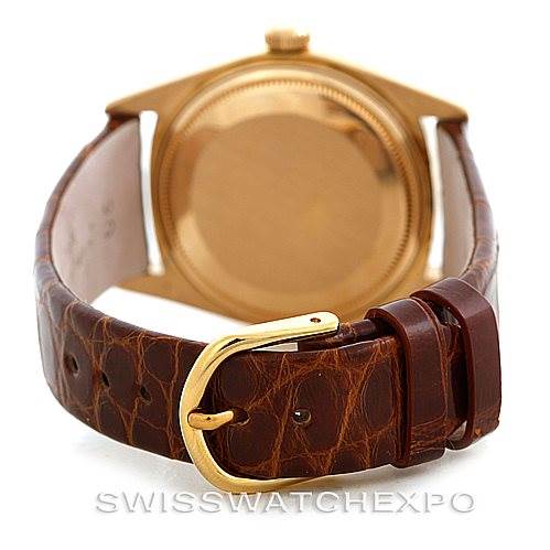 The image shows the back of a Rolex President 18038 Men's Yellow Gold Brown Dial 18038 Men's Yellow Gold Brown Dial model watch, focusing on its gold casing and brown leather strap with a gold buckle.