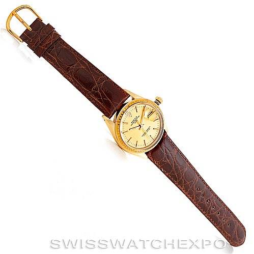 The image shows a Rolex President 1512 Men
s Yellow Gold Champagne Dial 1512 Men
s Yellow Gold Champagne Dial model watch with a brown leather strap, viewed from above.