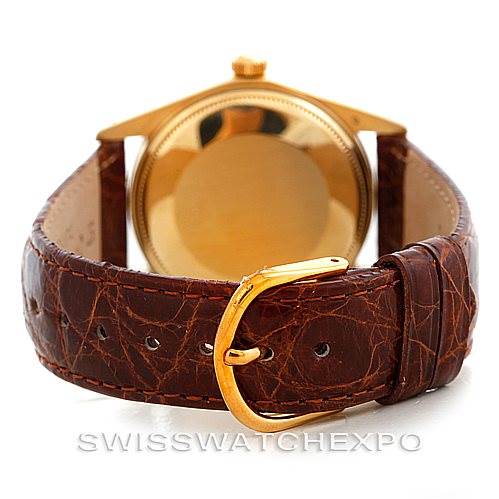 This image shows the back and strap of a Rolex President 1512 Men
s Yellow Gold Champagne Dial 1512 Men
s Yellow Gold Champagne Dial watch, highlighting the golden case and brown leather strap with a gold buckle.