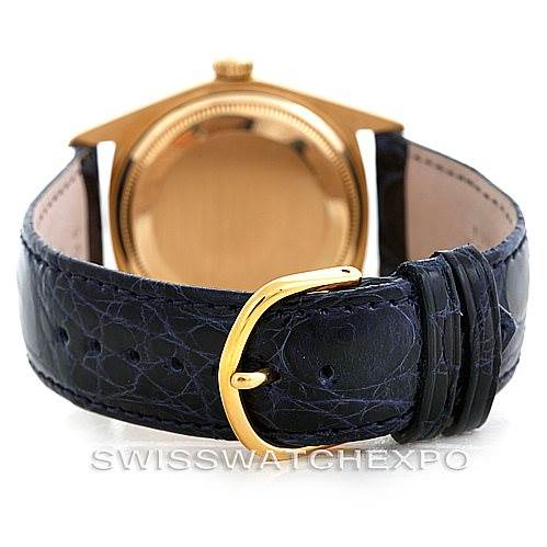 The image shows the backside of a Rolex President 1803 Men's Yellow Gold Blue Dial 1803 Men's Yellow Gold Blue Dial model watch, highlighting the case back and black leather strap with a gold buckle.