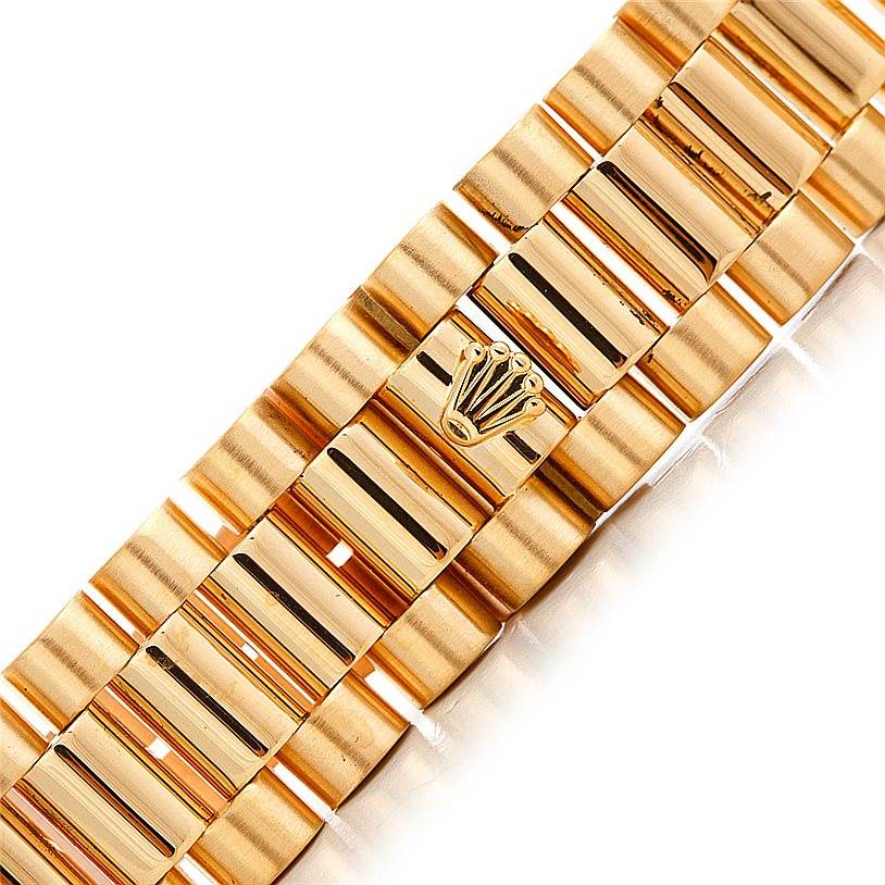 This is a close-up view of the gold bracelet of a Rolex President 18238 Men
s Yellow Gold Champagne Dial 18238 Men
s Yellow Gold Champagne Dial model, highlighting the Rolex logo clasp.