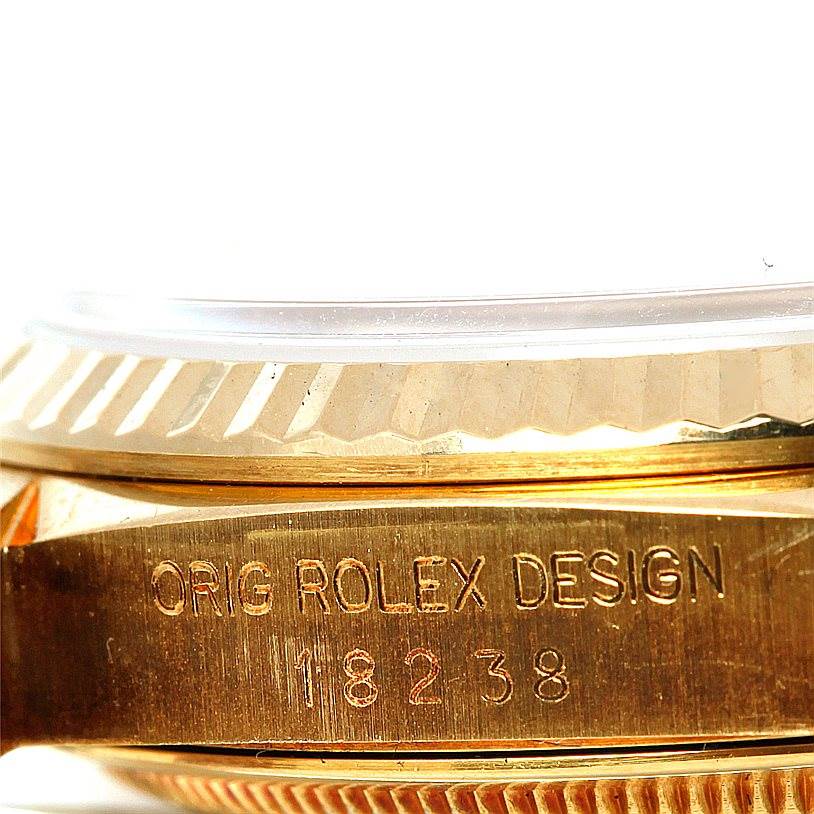 This close-up image shows the side view of the case and bezel of the Rolex President 18238 Men
s Yellow Gold Champagne Dial 18238 Men
s Yellow Gold Champagne Dial model, highlighting the engraved model number.