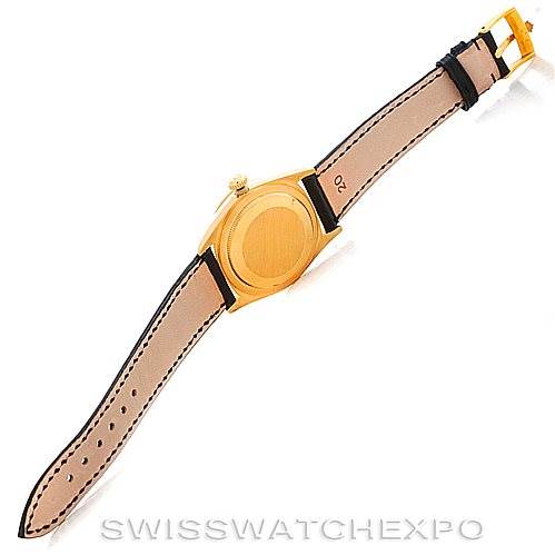 This image shows the underside and back case of a Rolex President 18238 Men's Yellow Gold Grey Dial 18238 Men's Yellow Gold Grey Dial model watch at an angle, including the leather strap and buckle.