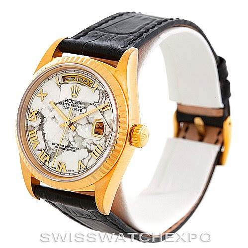 The image shows a side and front angle of a Rolex President 18238 Men's Yellow Gold Grey Dial 18238 Men's Yellow Gold Grey Dial model watch, highlighting the marbled face, gold case, and black leather strap.