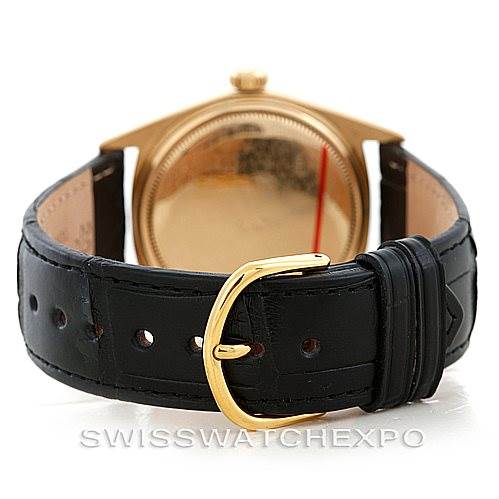 This image shows the back of a Rolex President 1803 Men
s Yellow Gold Silver Dial 1803 Men
s Yellow Gold Silver Dial model, focusing on the black leather strap and the gold buckle.