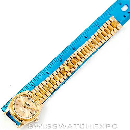 The image shows the Rolex President 18078 Men
s Yellow Gold Champagne Dial 18078 Men
s Yellow Gold Champagne Dial model watch laid flat with a full view of its dial, case, and bracelet, next to a blue ruler for scale.