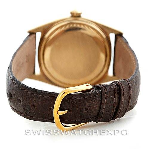 The image shows the back view of a Rolex President 1803 Men
s Yellow Gold Champagne Dial 1803 Men
s Yellow Gold Champagne Dial model watch with a leather strap and gold buckle.