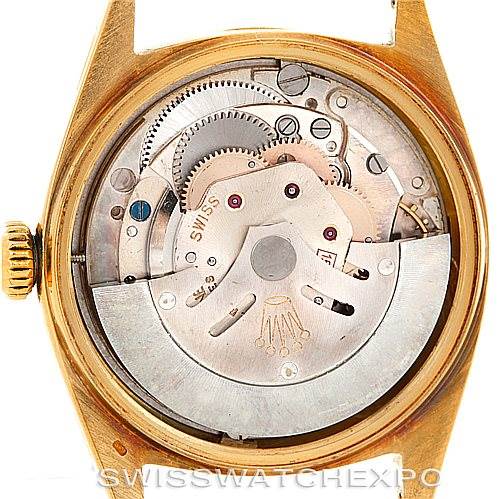 The image shows the back of a Rolex President 1803 Men
s Yellow Gold Champagne Dial 1803 Men
s Yellow Gold Champagne Dial model watch, revealing its intricate mechanical movement and internal components.