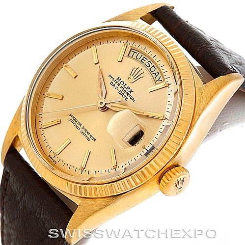 This image shows a Rolex President 1803 Men
s Yellow Gold Champagne Dial 1803 Men
s Yellow Gold Champagne Dial model watch from an angled perspective, highlighting its gold case, day-date feature, and brown leather strap.