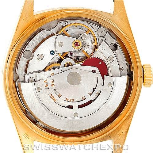 The image shows the back view of the Rolex President 18038 Men
s Yellow Gold Champagne Dial 18038 Men
s Yellow Gold Champagne Dial model, revealing its intricate internal movement and mechanisms.
