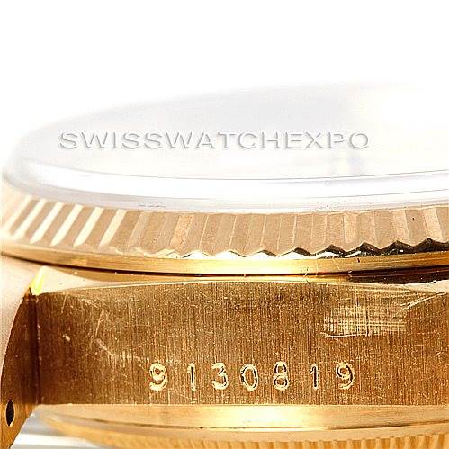 This image shows a close-up side view of a Rolex President 18038 Men
s Yellow Gold Champagne Dial 18038 Men
s Yellow Gold Champagne Dial model watch, focusing on the case, bezel, and serial number.