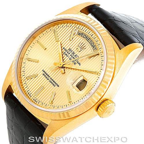 The Rolex President 18038 Men
s Yellow Gold Champagne Dial 18038 Men
s Yellow Gold Champagne Dial watch is shown at a front angle, highlighting its gold case, dial, crown, and black strap.