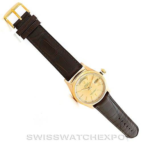 The image shows a Rolex President 18038 Men
s Yellow Gold Champagne Dial 18038 Men
s Yellow Gold Champagne Dial model watch positioned flat, displaying the face, leather strap, and gold buckle from above.