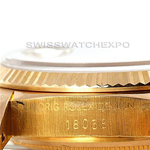 The image shows the side view of a Rolex President 18038 Men
s Yellow Gold Champagne Dial 18038 Men
s Yellow Gold Champagne Dial model watch, featuring the edge of the bezel and part of the case with "Orig Rolex Design" and the model number 18038 engraved.