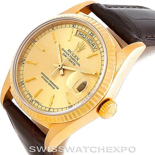 The image shows a Rolex President 18038 Men
s Yellow Gold Champagne Dial 18038 Men
s Yellow Gold Champagne Dial model watch from a three-quarter angle, highlighting its dial, day-date display, crown, and leather strap.