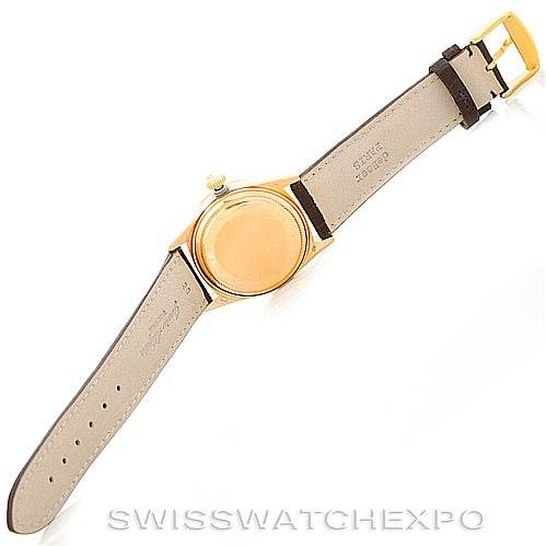 This image shows the back and band of a Rolex President 18038 Men
s Yellow Gold Champagne Dial 18038 Men
s Yellow Gold Champagne Dial watch, displaying the case and leather straps.