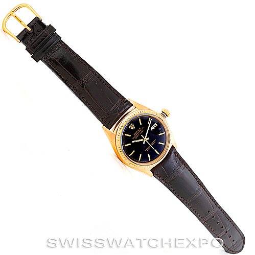 The image shows a Rolex President 1601 Men's Yellow Gold Black Dial 1601 Men's Yellow Gold Black Dial model watch from a top-down angle, highlighting its black leather strap, gold bezel, and blue dial.