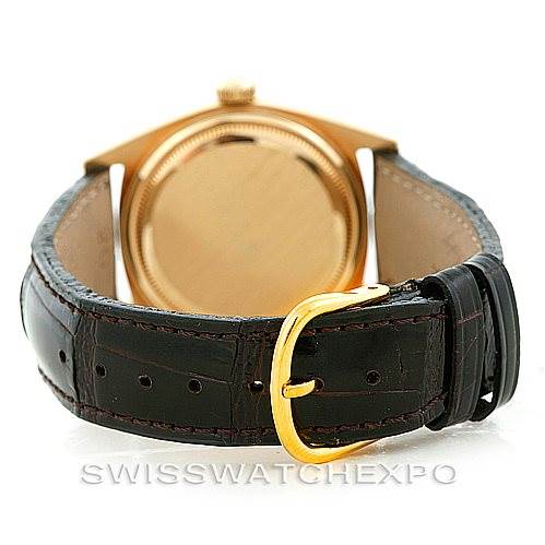 The image shows the back of a Rolex President 1601 Men's Yellow Gold Black Dial 1601 Men's Yellow Gold Black Dial model watch with a leather strap and a gold buckle.