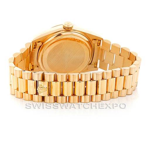 The image shows the back and band of a Rolex President 18038 Men
s Yellow Gold Champagne Dial 18038 Men
s Yellow Gold Champagne Dial model watch, highlighting its gold clasp and links.