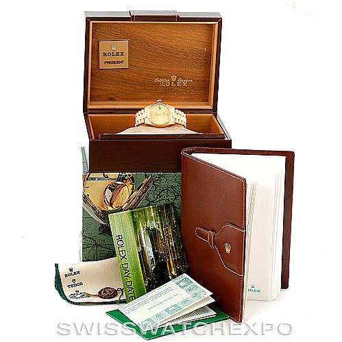 The image shows a Rolex President 18038 Men
s Yellow Gold Champagne Dial 18038 Men
s Yellow Gold Champagne Dial model watch in its box, along with manuals, certificates, and a leather folder.