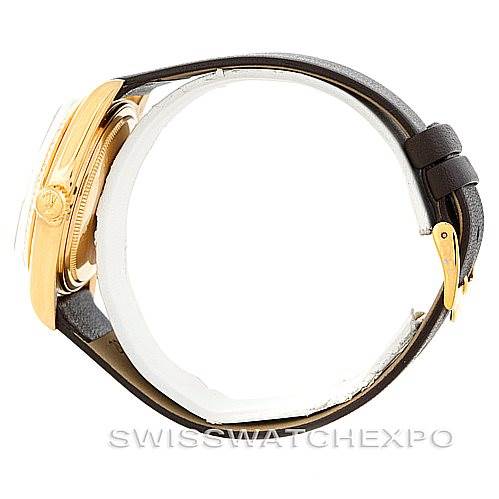 This side view of the Rolex President 1803 Men's Yellow Gold White Dial 1803 Men's Yellow Gold White Dial watch shows its gold case and black leather strap with a buckle.