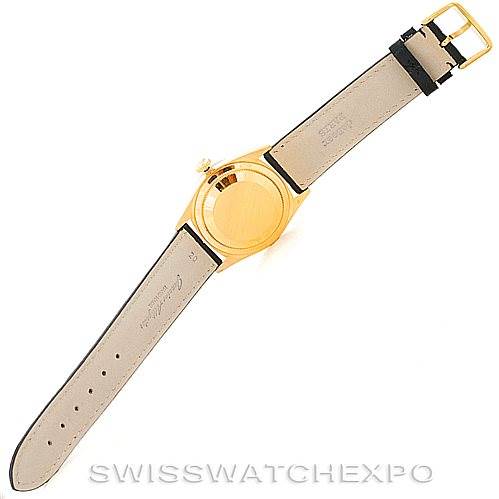 This is a rear view of a Rolex President 18238 Men
s Yellow Gold Champagne Dial 18238 Men
s Yellow Gold Champagne Dial watch, showing the case back, leather strap, and buckle.