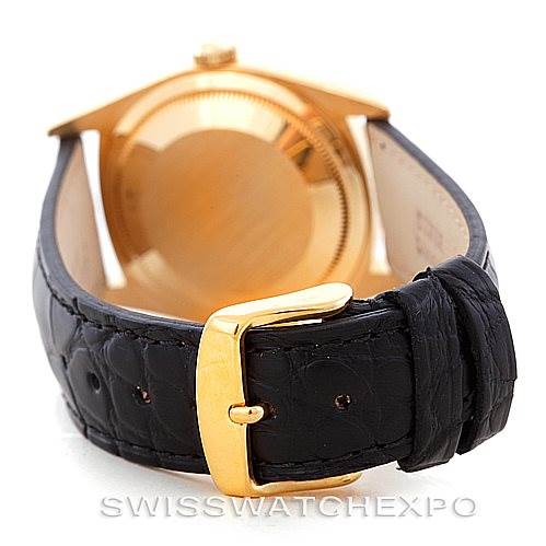 The image shows the back and clasp of a Rolex President 18238 Men
s Yellow Gold Champagne Dial 18238 Men
s Yellow Gold Champagne Dial model watch with a black leather strap and gold buckle.