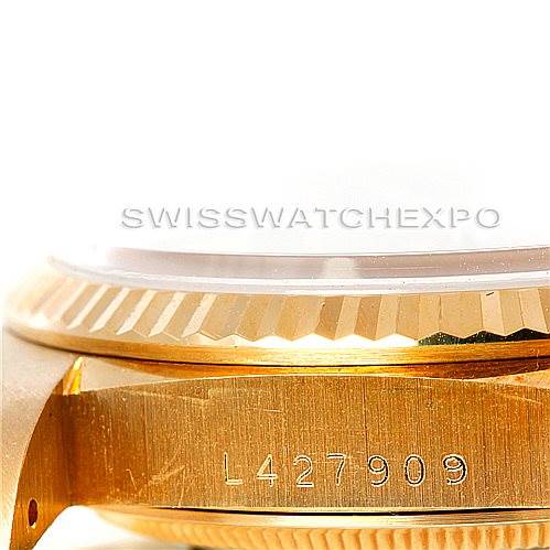 This image shows a close-up of the side of a Rolex President 18238 Men
s Yellow Gold Champagne Dial 18238 Men
s Yellow Gold Champagne Dial model watch, focusing on the serial number engraved on the case.