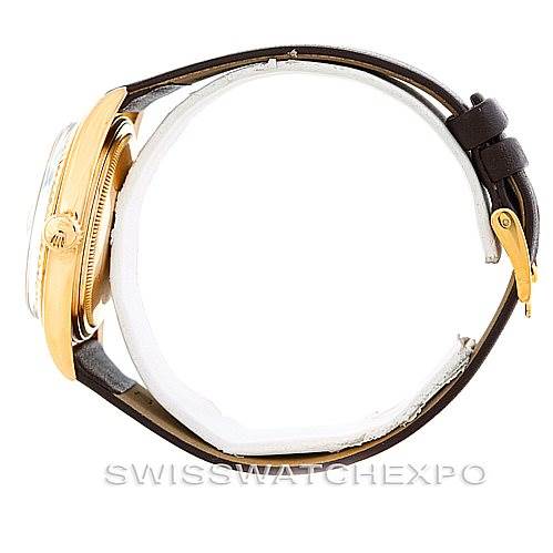 The Rolex President 1601 Men
s Yellow Gold Champagne Dial 1601 Men
s Yellow Gold Champagne Dial watch is shown from a side angle, highlighting the case, crown, and leather strap.